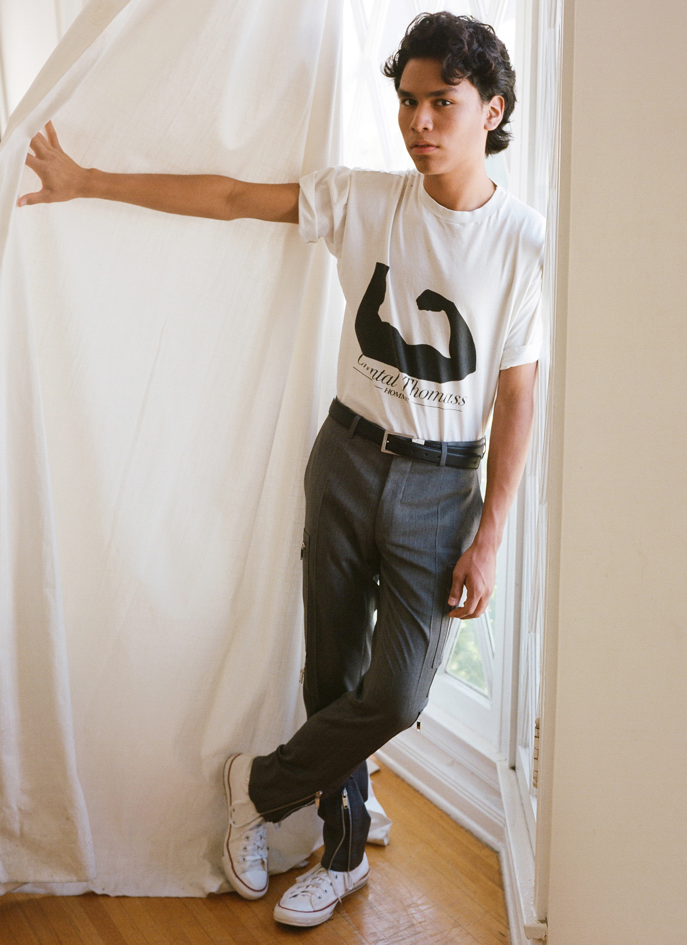 T-shirt, vintage Chantal Thomass from Chapel NYC. Trousers and belt by Dior Homme. Sneakers by Converse.